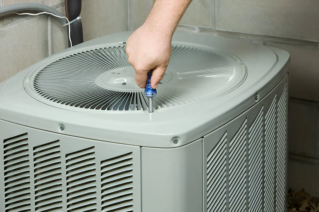 Emergency AC repair technician fixing a unit at night in Los Angeles, CA